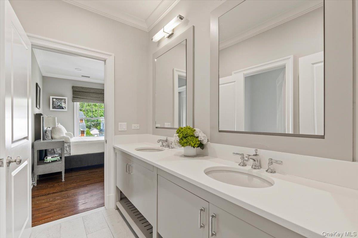 81 Wappanocca Avenue Rye, NY 10580 - Photo 16 of 27 Ensuite bathroom featuring double vanity and crown molding