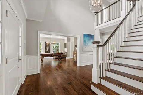 a view of entryway with wooden floor and stairs