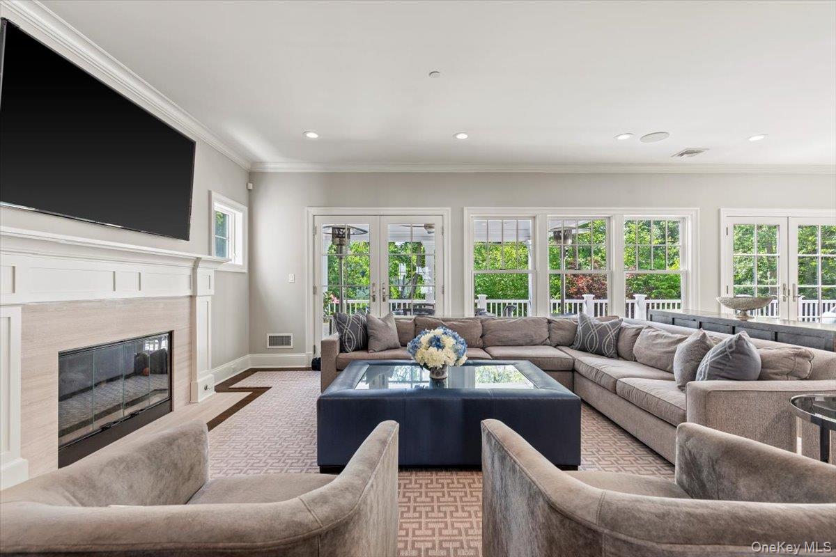 81 Wappanocca Avenue Rye, NY 10580 - Photo 6 of 27 Living room with a premium fireplace, recessed lighting, ornamental molding, and french doors