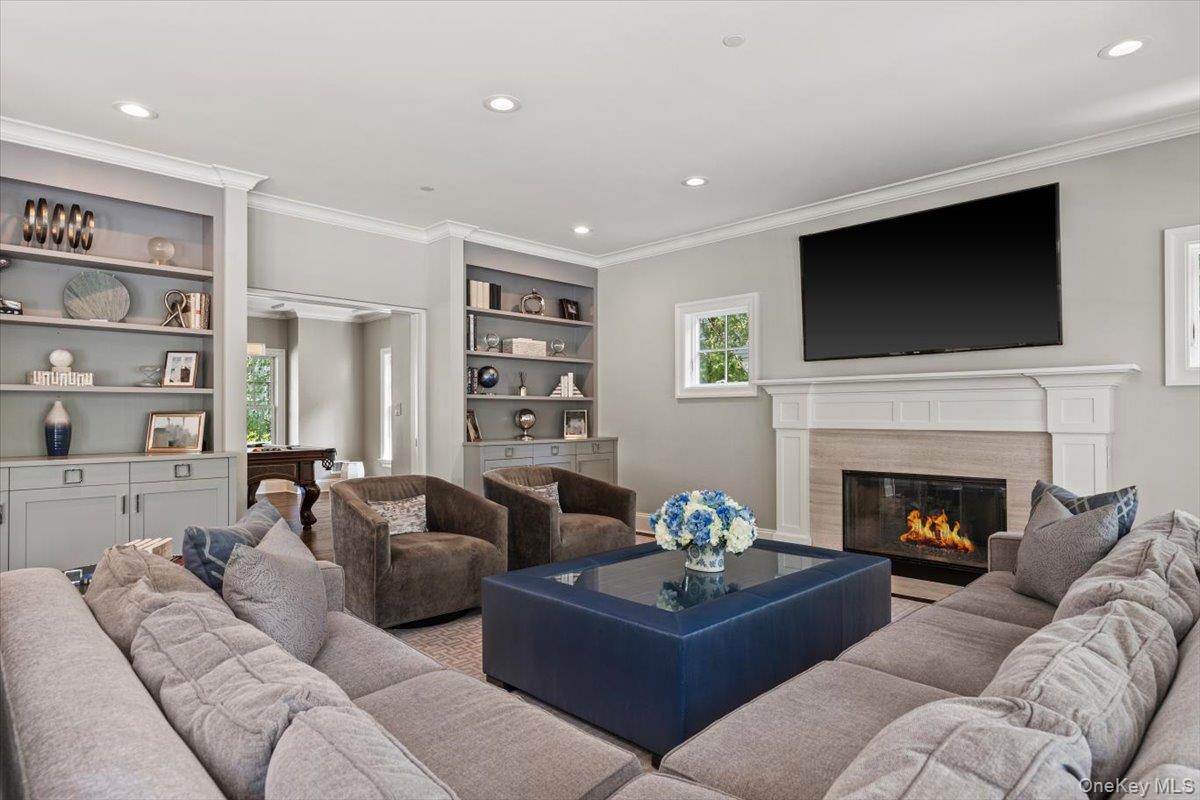 81 Wappanocca Avenue Rye, NY 10580 - Photo 7 of 27 Living area with ornamental molding, recessed lighting, a premium fireplace, and built in features
