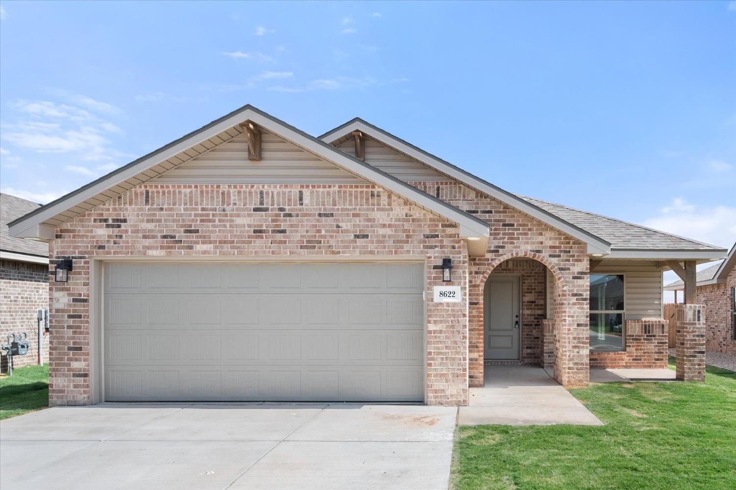 8622 26th Street Lubbock, TX 79407 - Photo 1 of 16 a front view of a house with garden