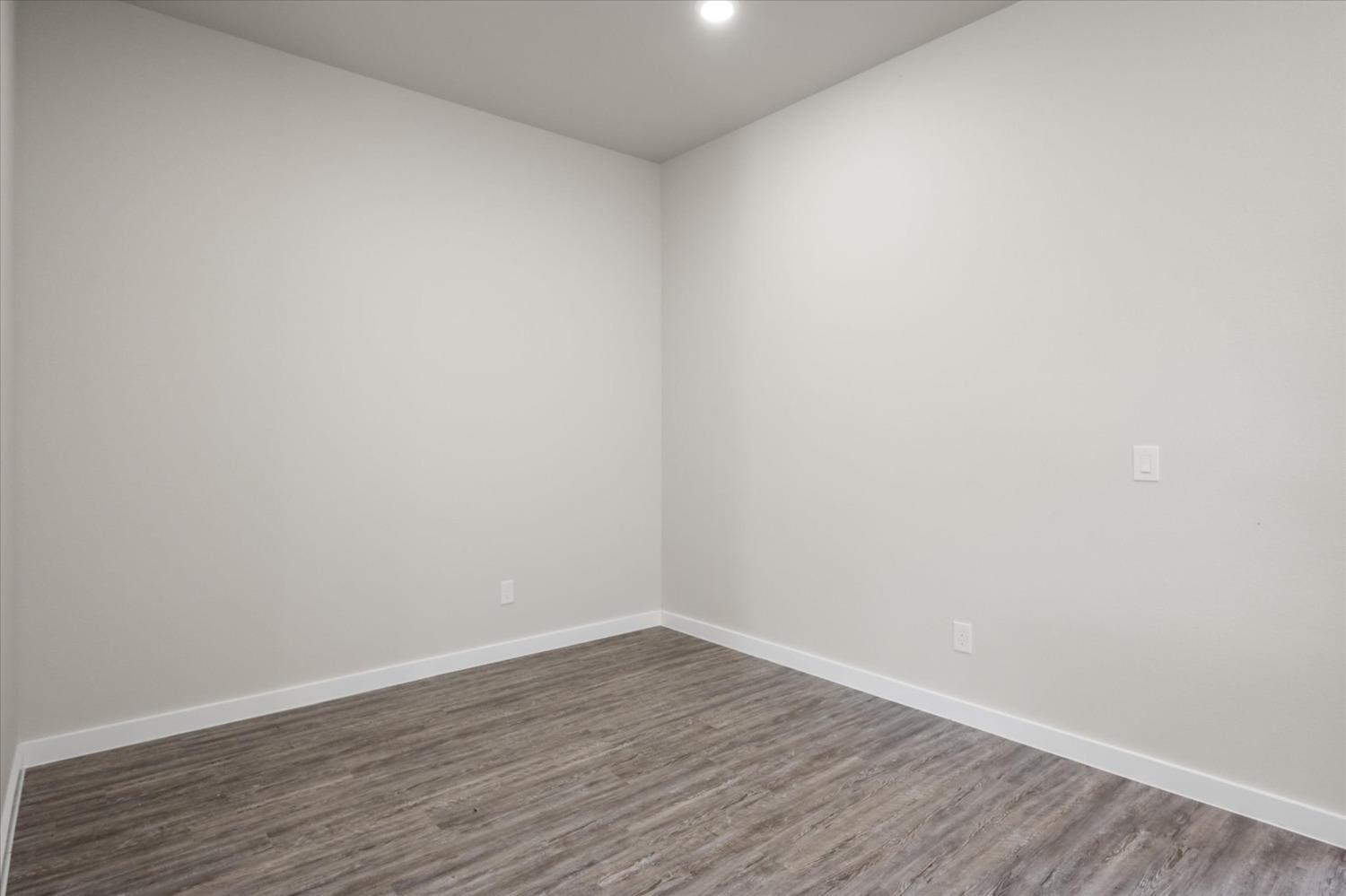 8622 26th Street Lubbock, TX 79407 - Photo 12 of 16 a view of an empty room with wooden floor
