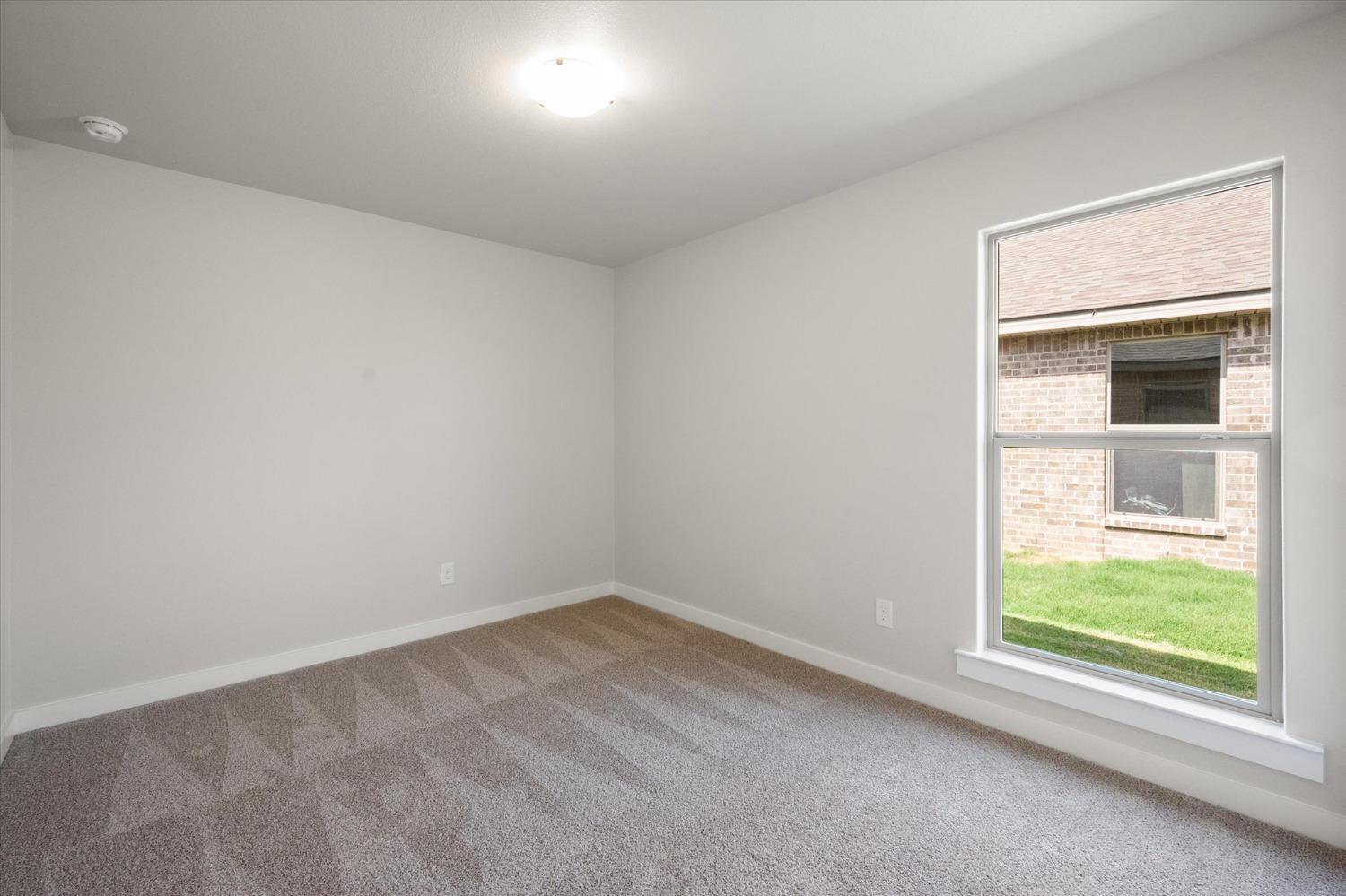 8622 26th Street Lubbock, TX 79407 - Photo 9 of 16 an empty room with a window