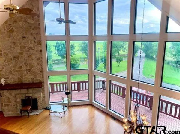 a view of an empty room with a floor to ceiling window and a table