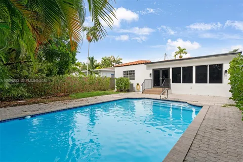 a view of a house with swimming pool and sitting area