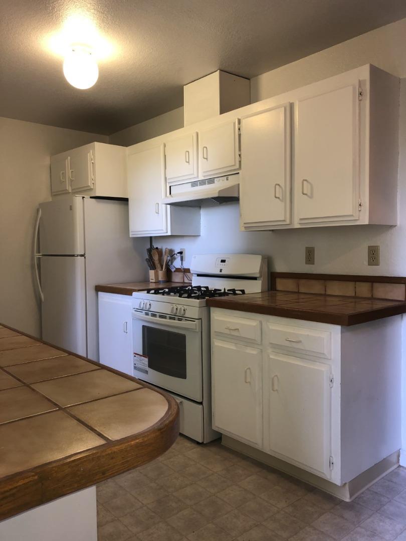 4020 Ridge Circle Willits, CA 95490 - Photo 17 of 44 a kitchen with stainless steel appliances granite countertop a sink refrigerator stove and white cabinets