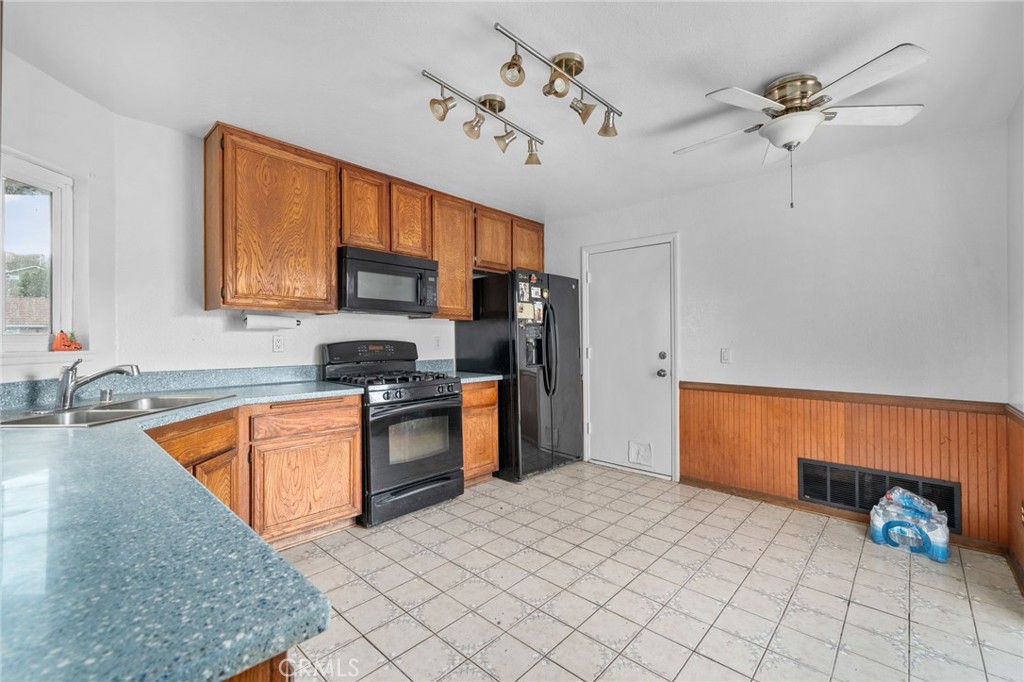 5423 Dunlop Drive Riverside, CA 92505 - Photo 11 of 28 a kitchen with stainless steel appliances granite countertop a sink refrigerator stove and microwave