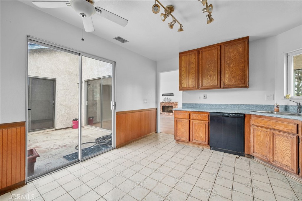 5423 Dunlop Drive Riverside, CA 92505 - Photo 13 of 28 a kitchen with stainless steel appliances kitchen island granite countertop a sink and cabinets