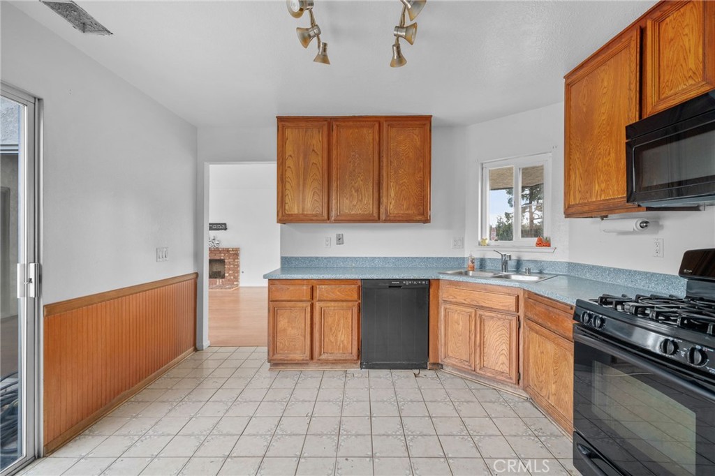 5423 Dunlop Drive Riverside, CA 92505 - Photo 14 of 28 a kitchen with stainless steel appliances granite countertop a stove top oven a sink a counter space and cabinets