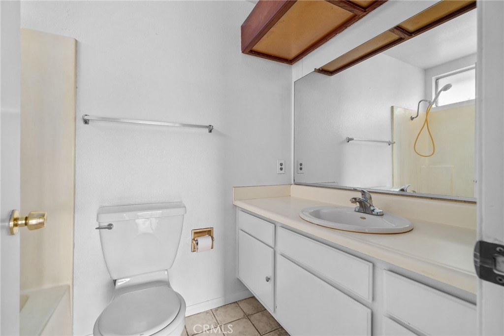 5423 Dunlop Drive Riverside, CA 92505 - Photo 20 of 28 a bathroom with a granite countertop sink toilet and shower