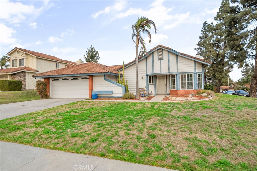 5423 Dunlop Drive Riverside, CA 92505 - Photo 2 of 28 a front view of a house with a garden and yard