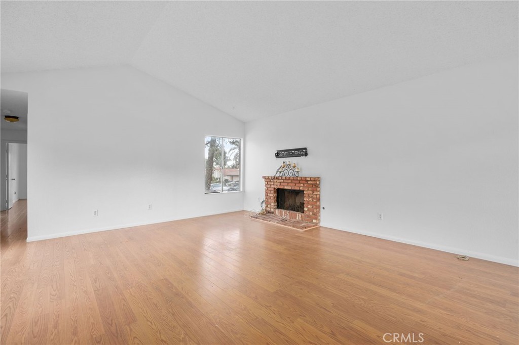 5423 Dunlop Drive Riverside, CA 92505 - Photo 6 of 28 a view of empty room with wooden floor and fireplace