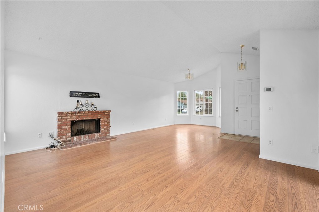 5423 Dunlop Drive Riverside, CA 92505 - Photo 8 of 28 an empty room with windows and fireplace