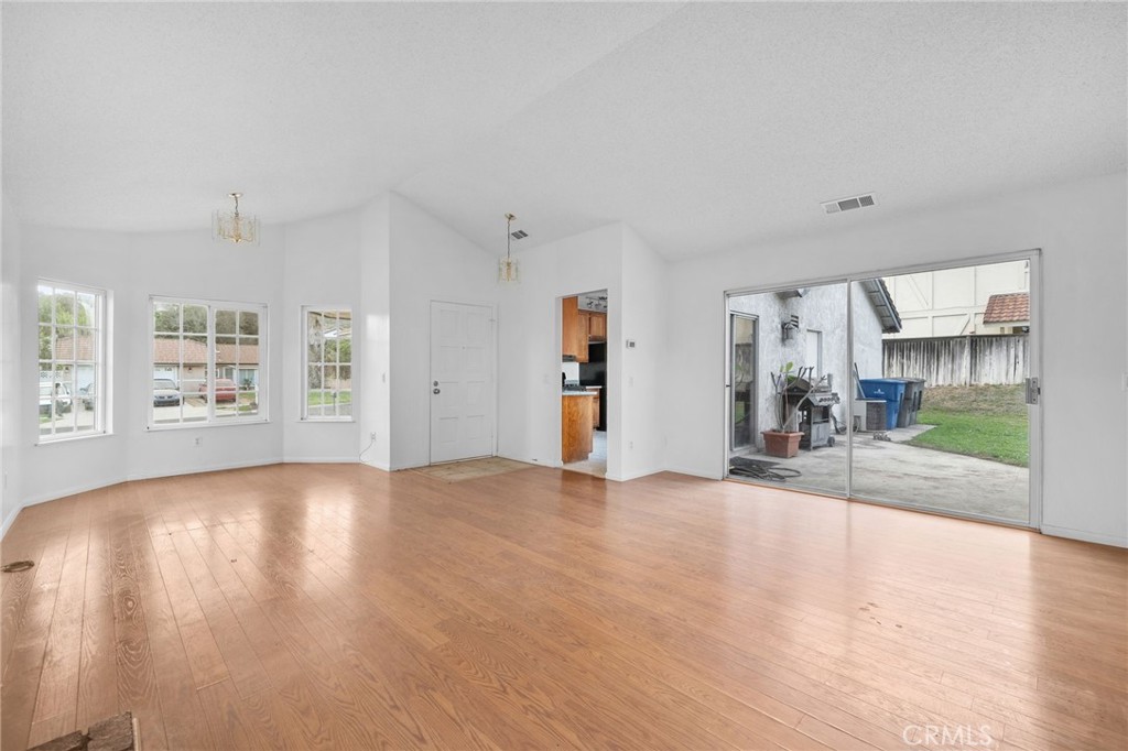 5423 Dunlop Drive Riverside, CA 92505 - Photo 10 of 28 a view of empty room with wooden floor and windows
