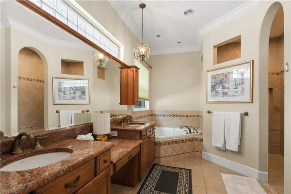 a bathroom with double vanity sinks a mirror and a shower