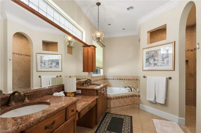 a bathroom with double vanity sinks a mirror and a shower