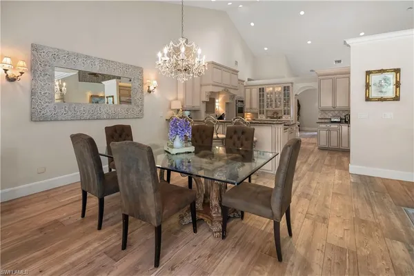 a view of a dining room with furniture and chandelier