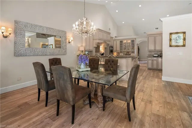 a view of a dining room with furniture and chandelier
