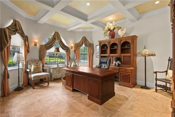 a view of a dining room with furniture a chandelier and a large window