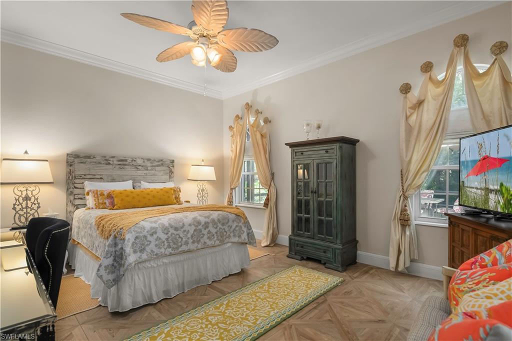 649 Bow Line Drive Naples, FL 34103 - Photo 24 of 31 a bedroom with a bed and a chandelier