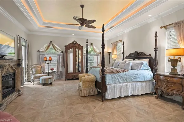 a spacious bedroom with a bed couch and window