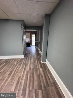 a view of a room with wooden floor