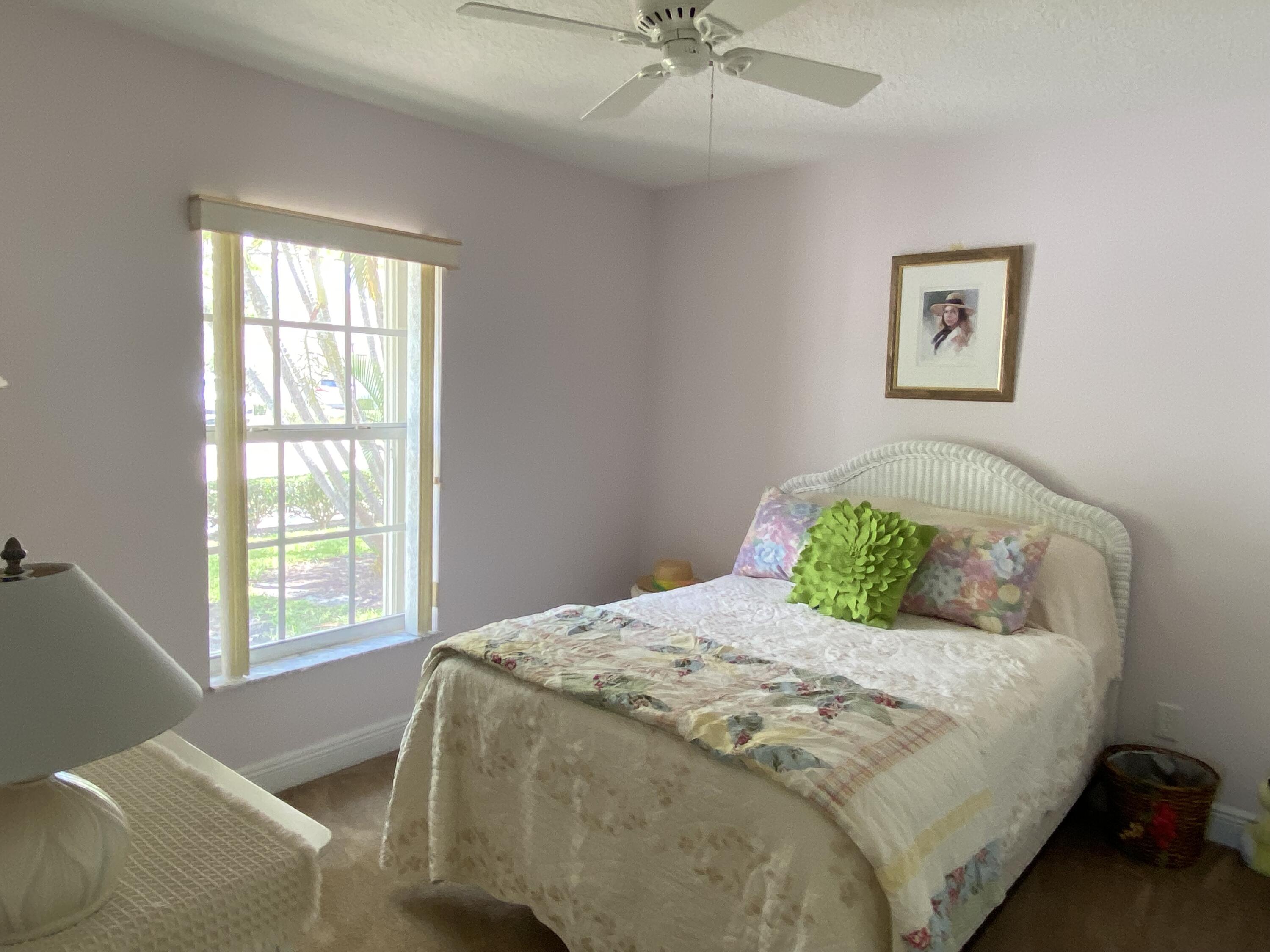 225 Clocktower Drive Jupiter, FL 33458 - Photo 19 of 40 a bedroom with a bed and window