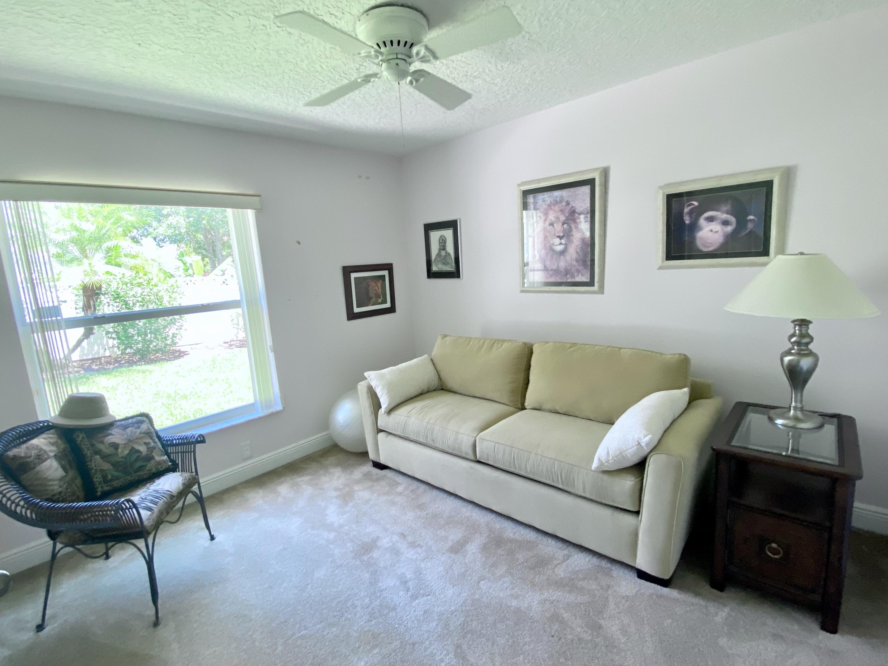 225 Clocktower Drive Jupiter, FL 33458 - Photo 21 of 40 a living room with furniture and a window
