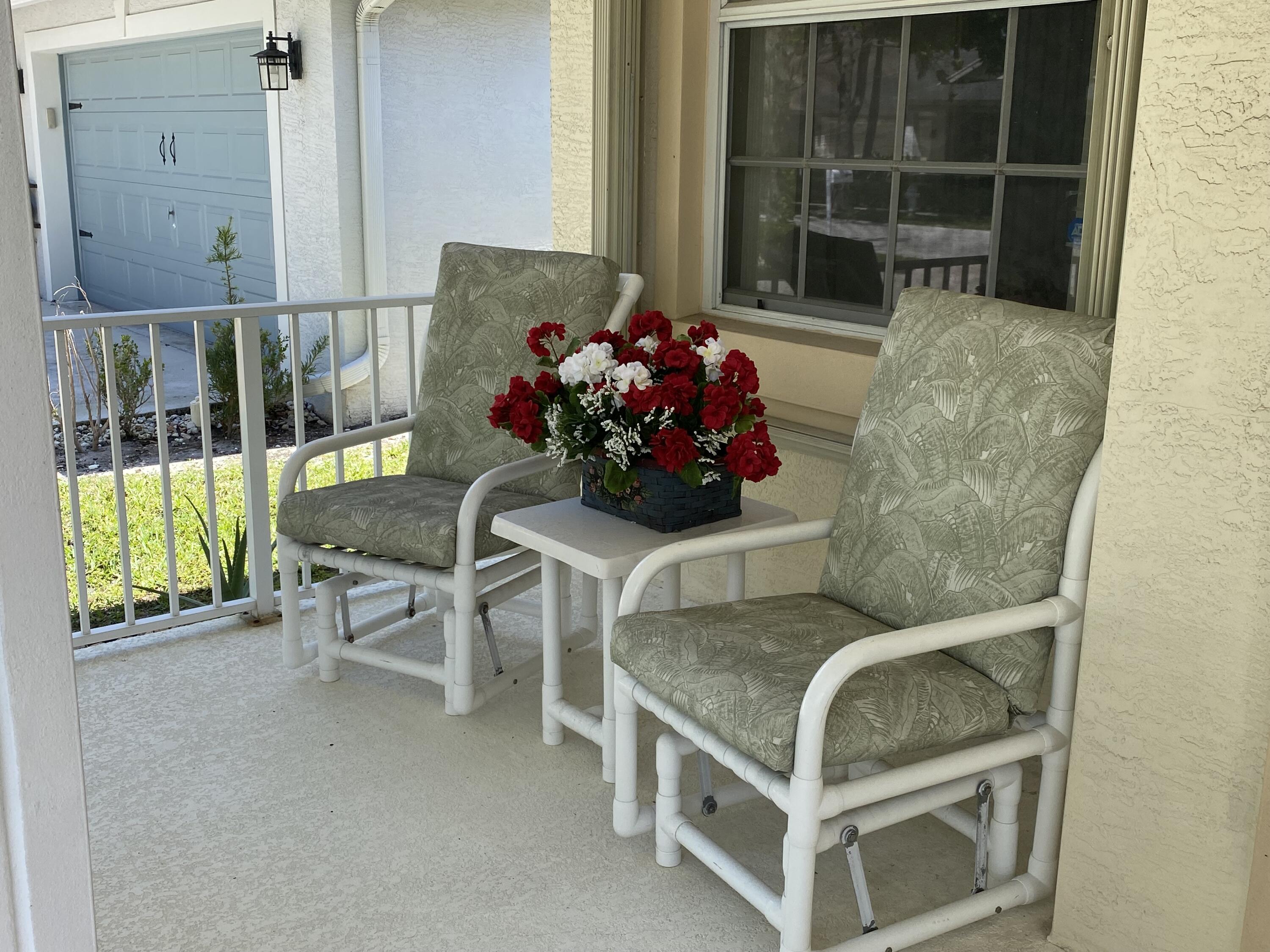 225 Clocktower Drive Jupiter, FL 33458 - Photo 4 of 40 a living room with furniture and a potted plant