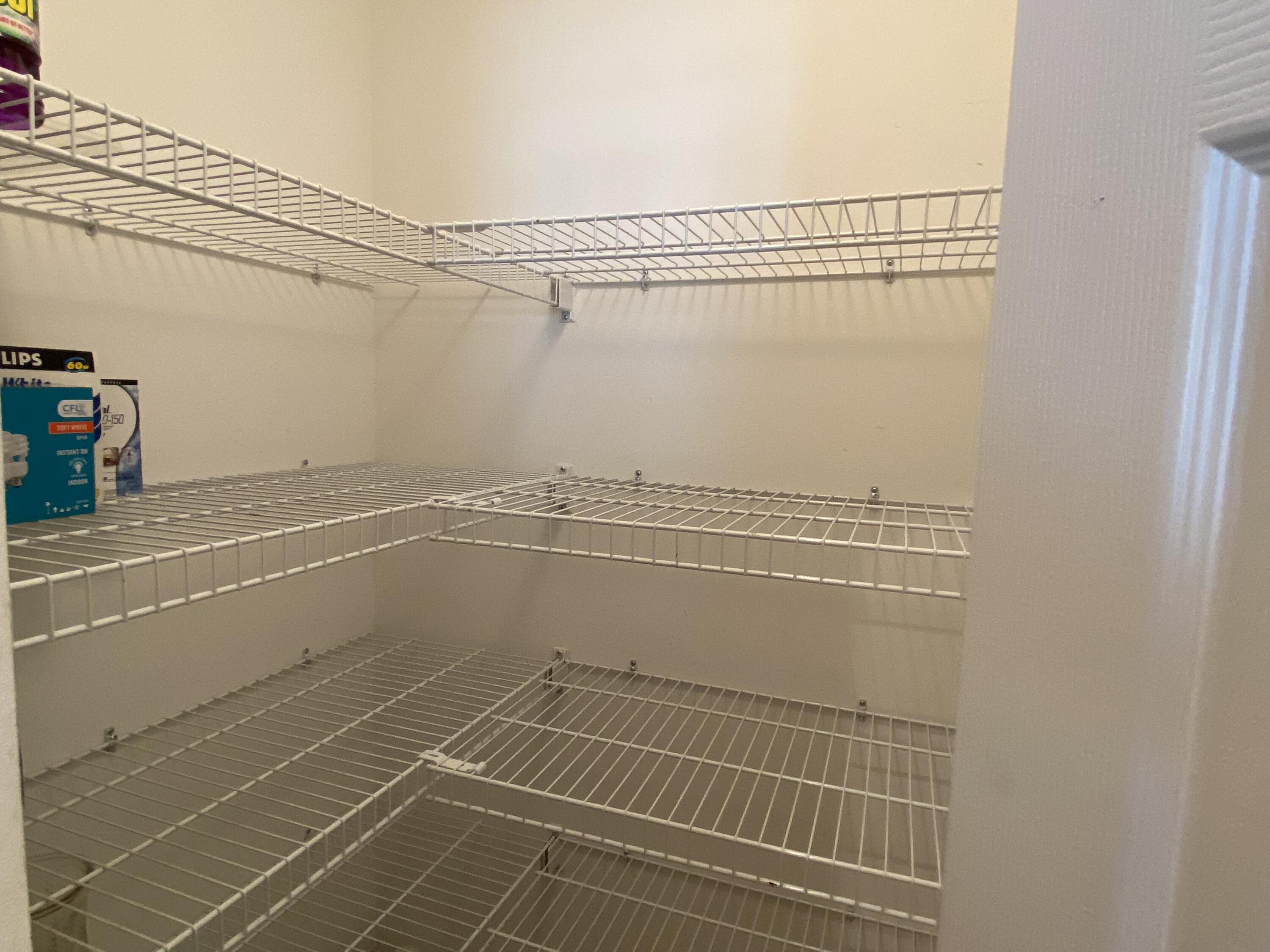 225 Clocktower Drive Jupiter, FL 33458 - Photo 9 of 40 a view of a room with racks on the wall