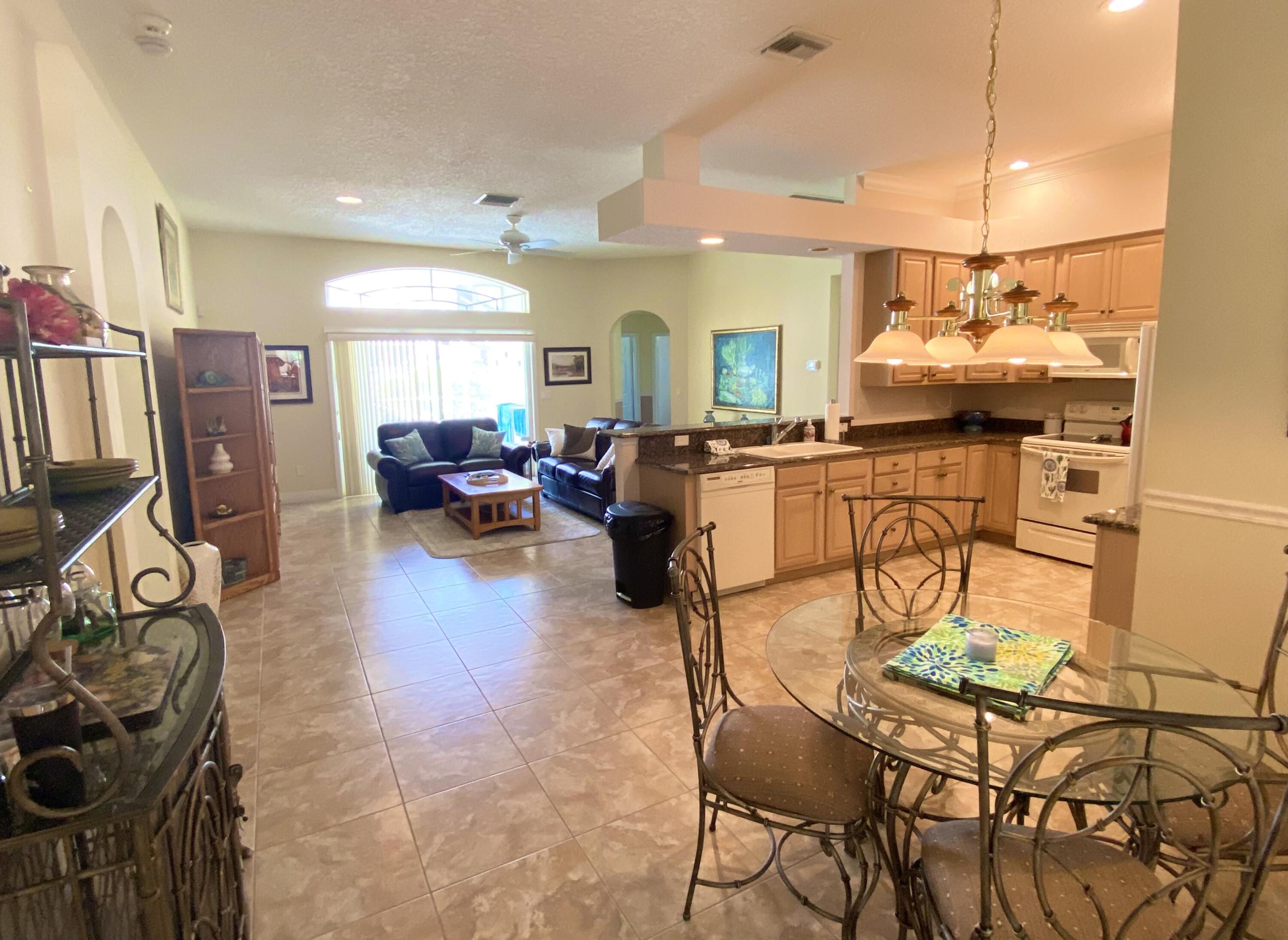 225 Clocktower Drive Jupiter, FL 33458 - Photo 10 of 40 a living room with furniture a air conditioner vent and a window