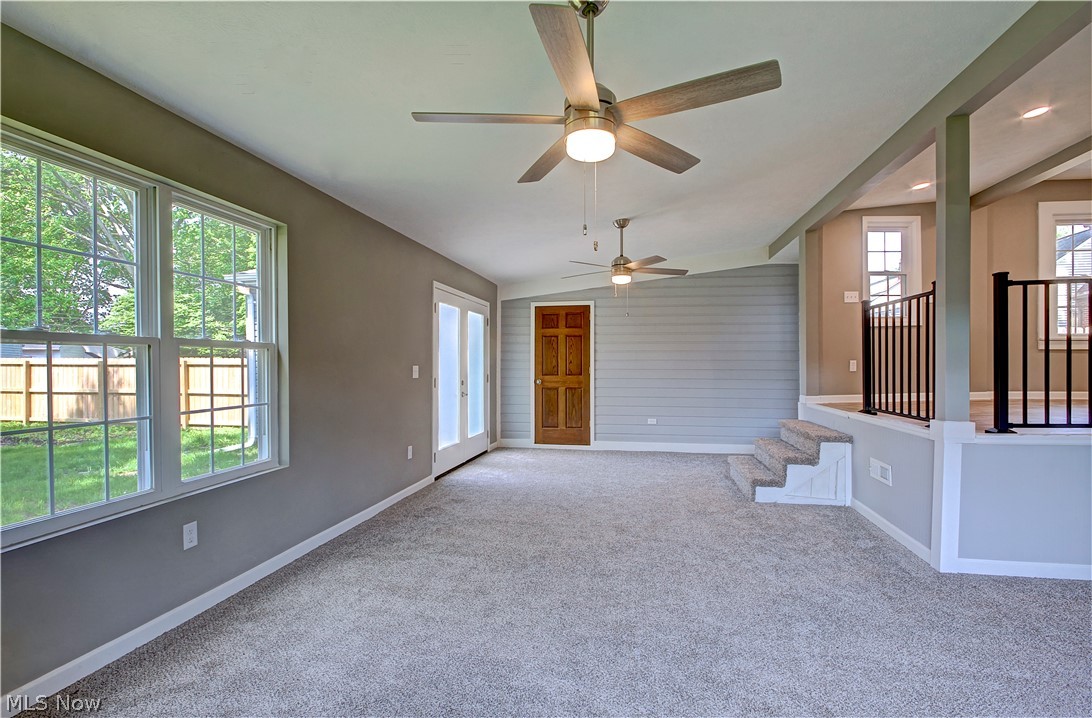 14507 Glencliffe Road Cleveland, OH 44111 - Photo 15 of 31 Unfurnished living room with carpet, ceiling fan, and lofted ceiling