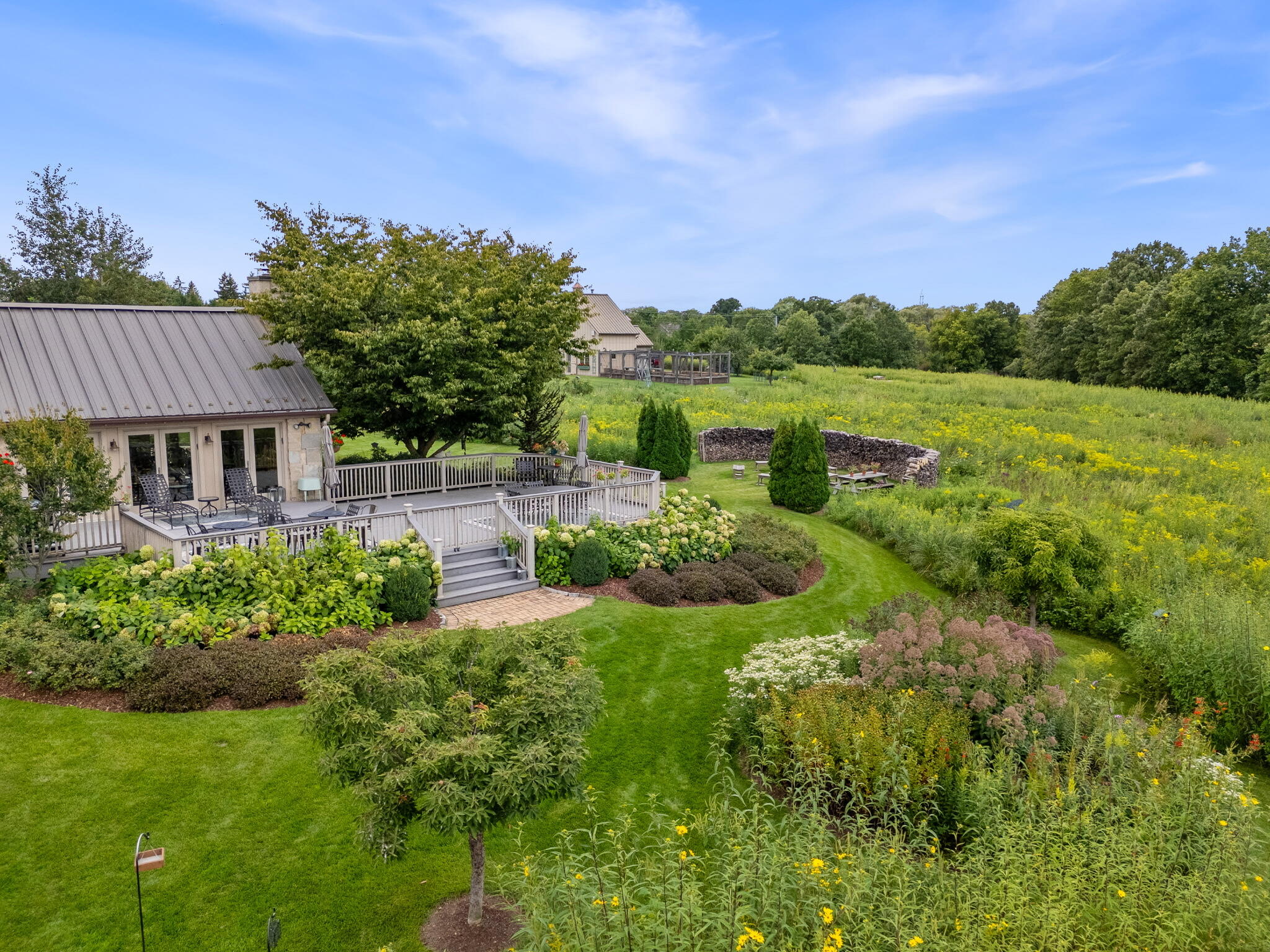 3200 West Bonniwell Road Mequon, WI 53097 - Photo 41 of 77 Aerial shot of deck, overlooking pollinator gardens and native plant species.