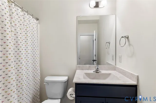 a bathroom with a toilet a sink and shower