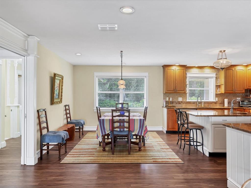4708 Hidden River Road Sarasota, FL 34240 - Photo 14 of 67 a view of a dining room with furniture window and wooden floor