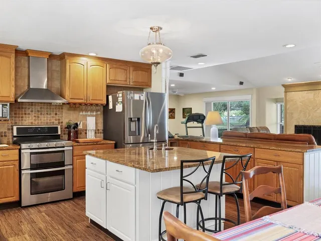 a view of double vanity sink a mirror a window and a lamp