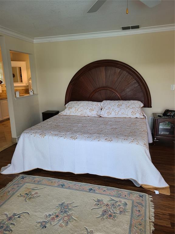 4708 Hidden River Road Sarasota, FL 34240 - Photo 22 of 67 a bedroom with a bed and wooden floor