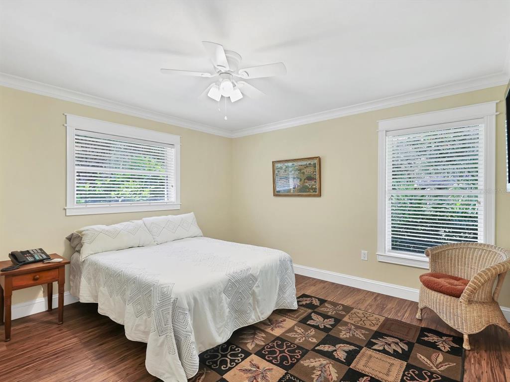 4708 Hidden River Road Sarasota, FL 34240 - Photo 26 of 67 a bedroom with a bed and wooden floor