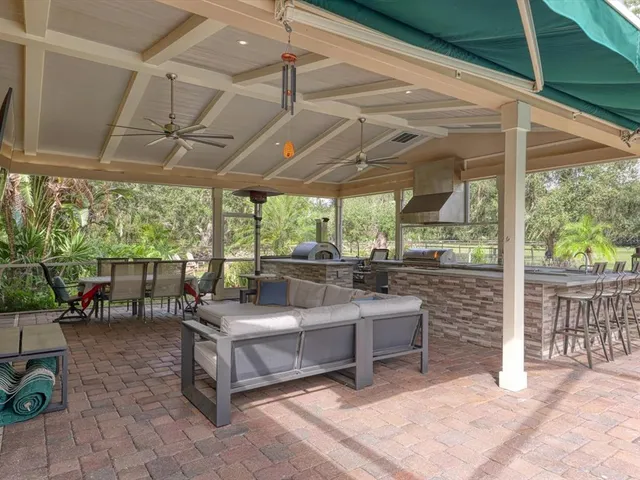a living room filled with furniture and a floor to ceiling window