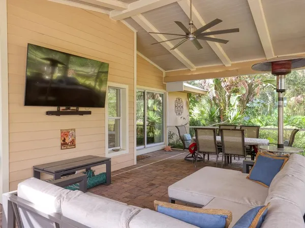 a view of a porch with furniture and wooden floor