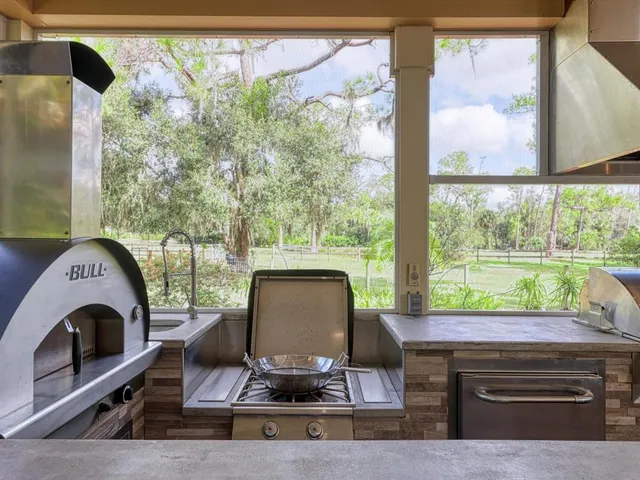 a view of a porch with furniture and wooden floor