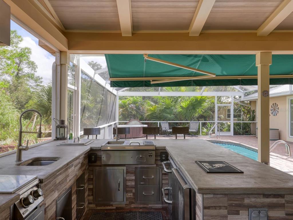 4708 Hidden River Road Sarasota, FL 34240 - Photo 36 of 67 a kitchen with a sink and a large window