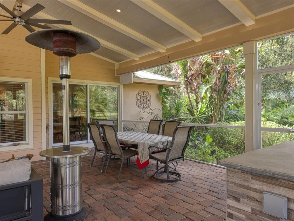 4708 Hidden River Road Sarasota, FL 34240 - Photo 38 of 67 a view of a porch with furniture and wooden floor