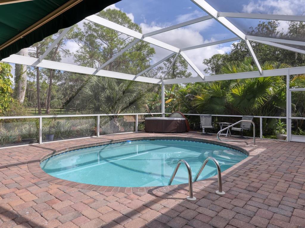 4708 Hidden River Road Sarasota, FL 34240 - Photo 39 of 67 a view of a swimming pool with a porch