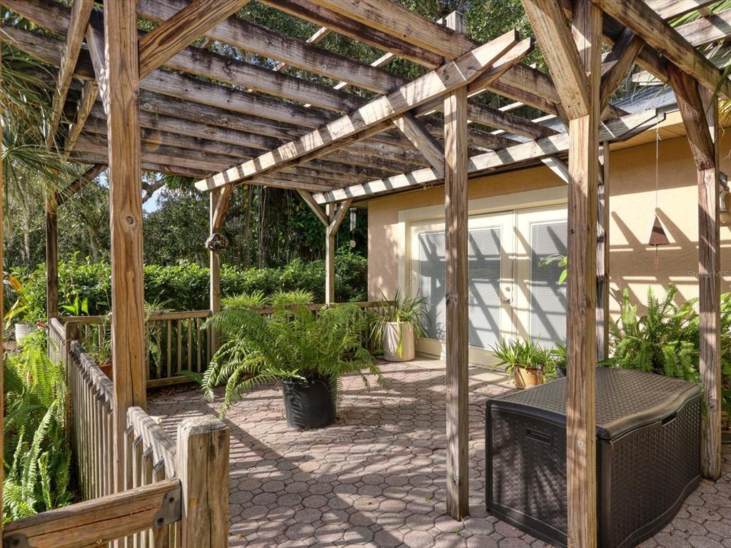 4708 Hidden River Road Sarasota, FL 34240 - Photo 44 of 67 a view of a porch with furniture and wooden floor