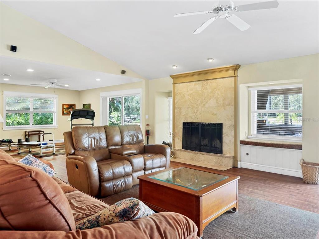 4708 Hidden River Road Sarasota, FL 34240 - Photo 9 of 67 a living room with furniture and a fireplace