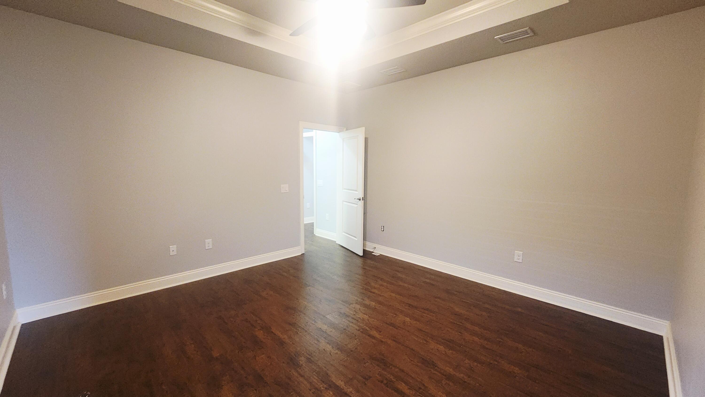 2133 Janet Street Navarre, FL 32566 - Photo 9 of 14 a view of an empty room with wooden floor