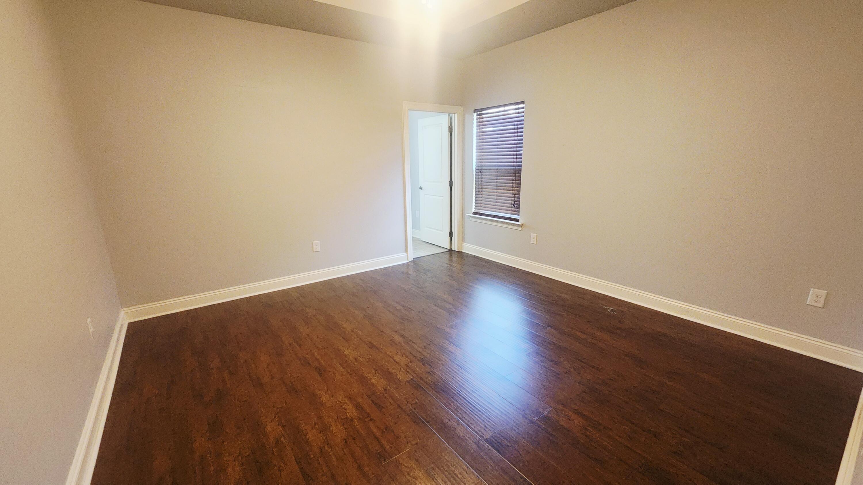 2133 Janet Street Navarre, FL 32566 - Photo 10 of 14 a view of an empty room with wooden floor
