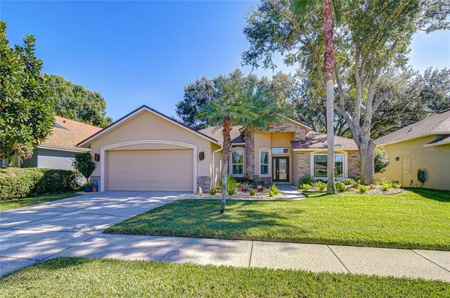 a front view of house with yard and green space