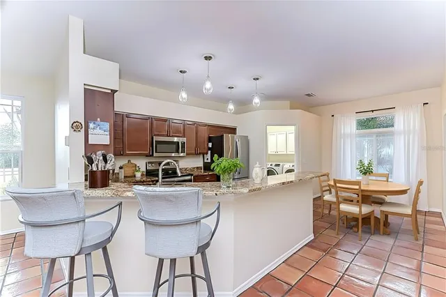 a kitchen with sink cabinets and living room
